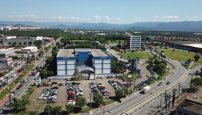 Vista aérea do Paço Municipal Raphael Vitiello, sede da Prefeitura de Guarujá, localizado em Vicente de Carvalho, com avenidas, prédios e áreas verdes ao redor.